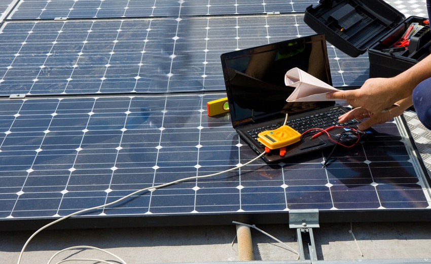 Technician performing maintenance on solar panel modules